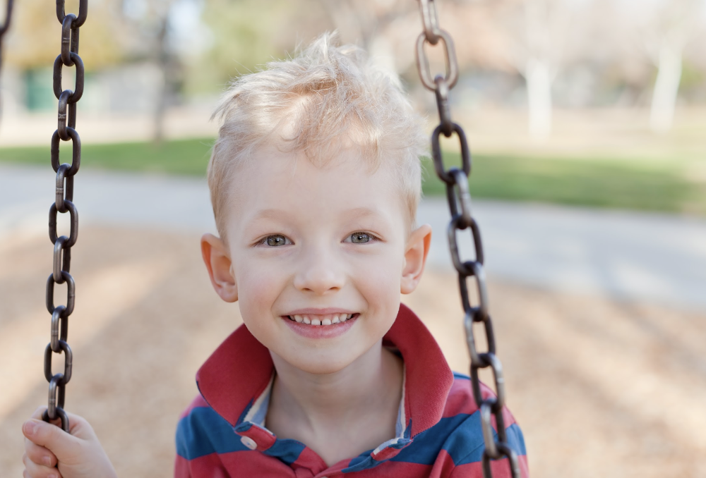 child smiling with pearly white teeth
